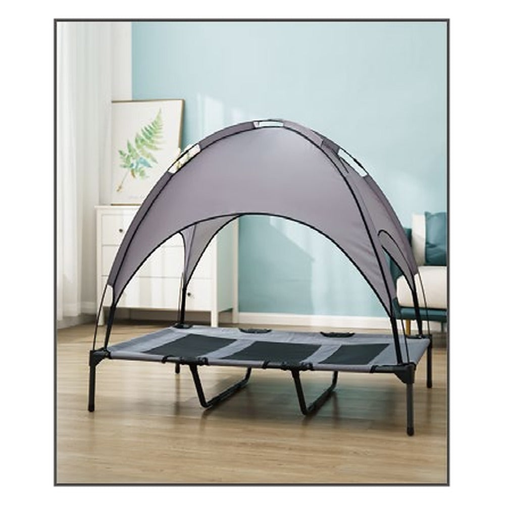 Elevated dog bed with canopy used indoors on a wood floor
